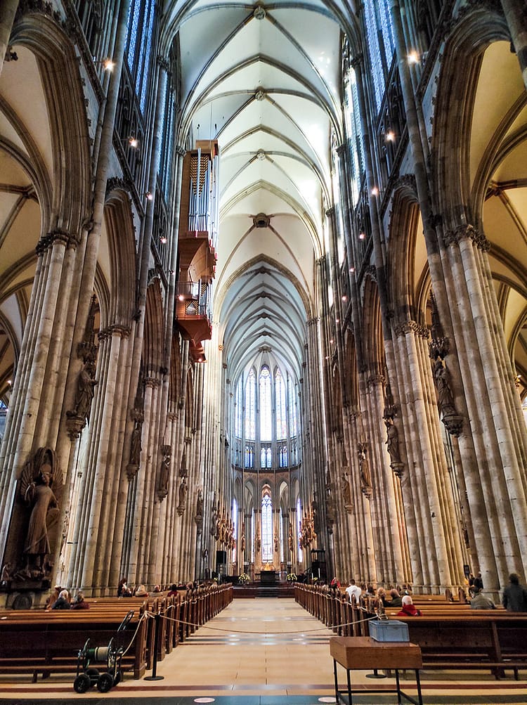 Inside pillars and architecture of Kölner Dom (Cologne Cathedral). View overlooking middle aisle up to alter