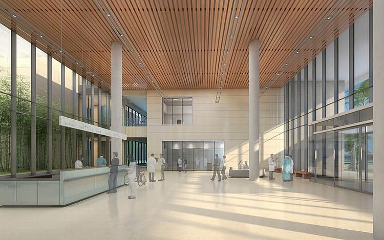Large and bright reception area of Serena del Mar hospital. Neutral tones with brown wood ceiling and large glass windows acting as divisions between outside and inside. Thus, allowing for plenty of light to shine through.