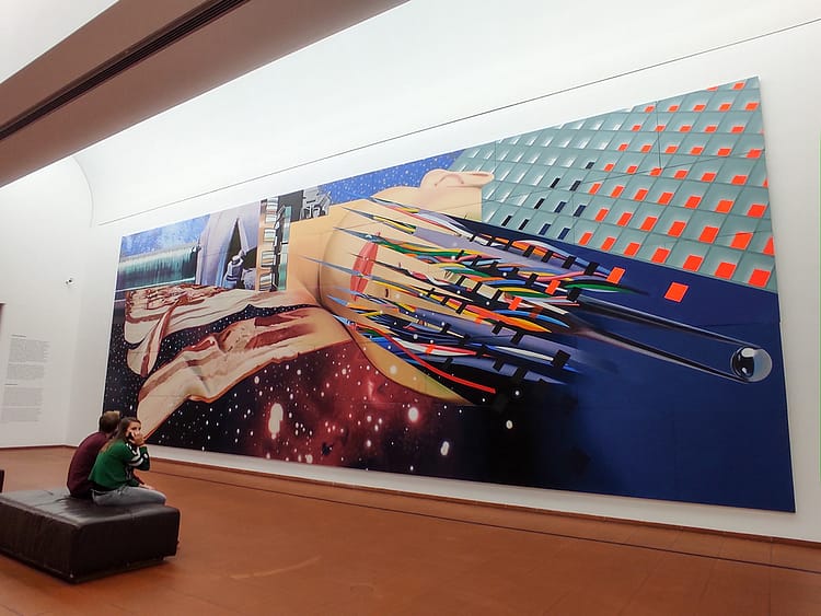 Large long artwork on the wall in Ludwig Museum with two people on a seat looking at it on the floor. Colorful artwork by James Rosenquist called Star Thief, (1980)