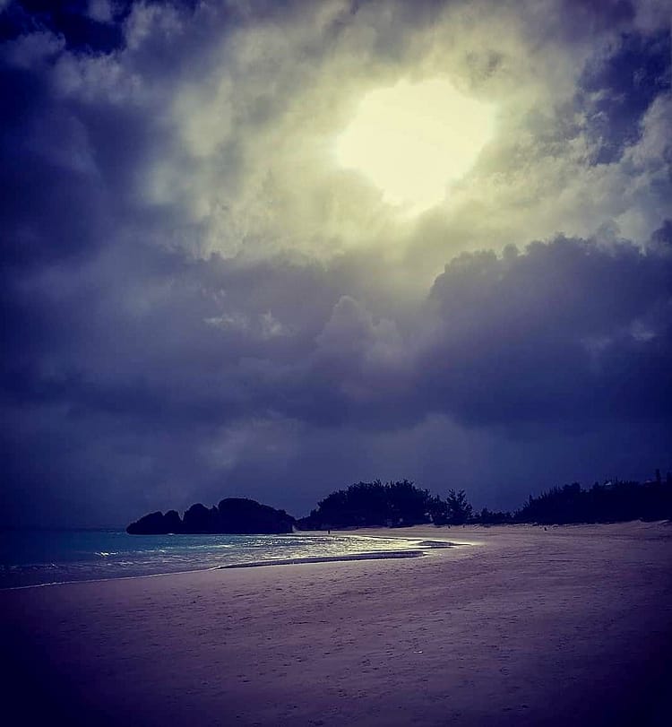 Dark stormy clouds at sunset over the beach in Bermuda.