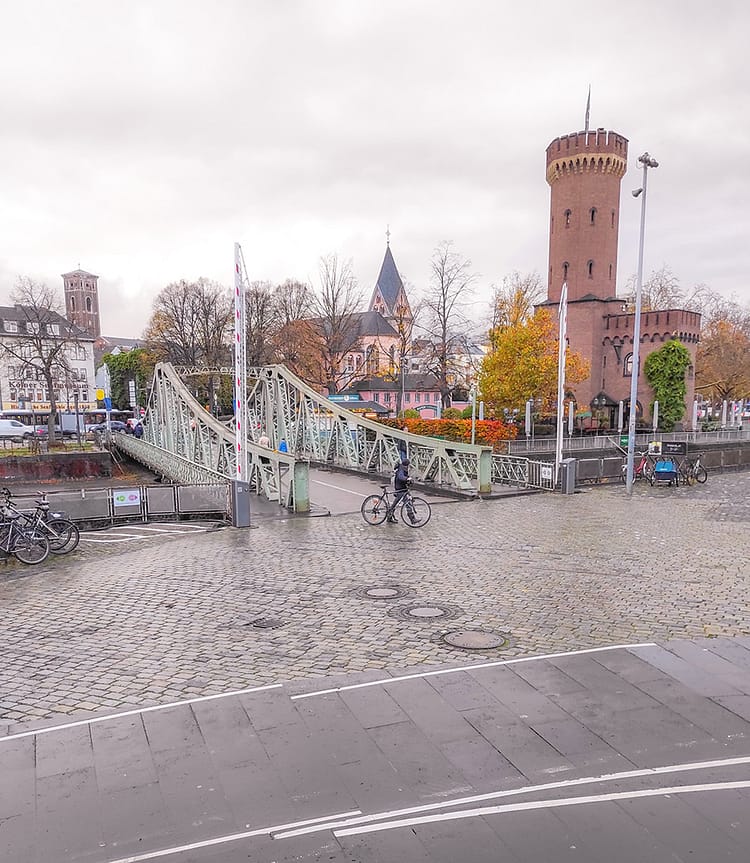 Bridge to Cologne Chocolate Museum, with view of St. Maria in Lyskirchen and Cologne swing bridge