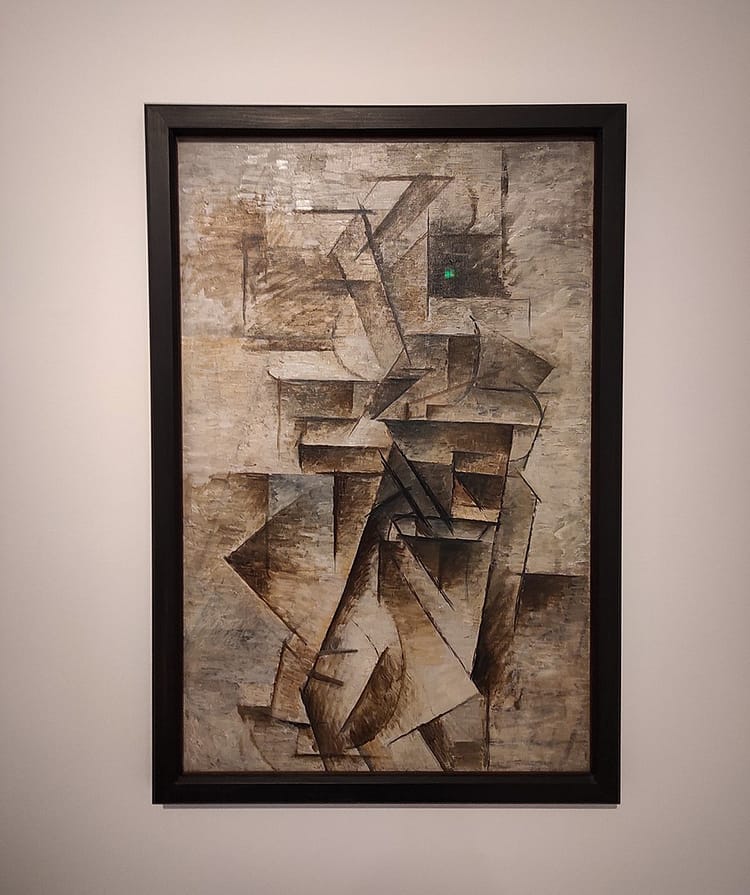 Oil on canvas artwork by Picasso of linear scaffolding shifts and defined angles with only a faint trace of a female figure. Called Woman with a Mandolin and is on display in Ludwig Museum